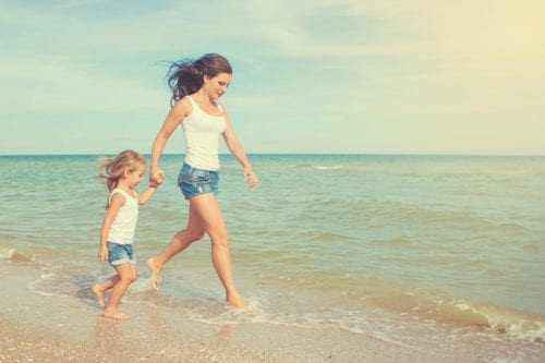Mom with a kid on the beach