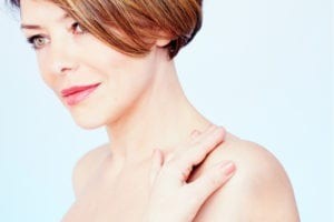 woman touching her shoulder