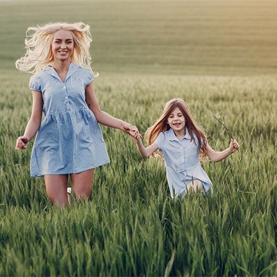 mom and kid playing in the fields